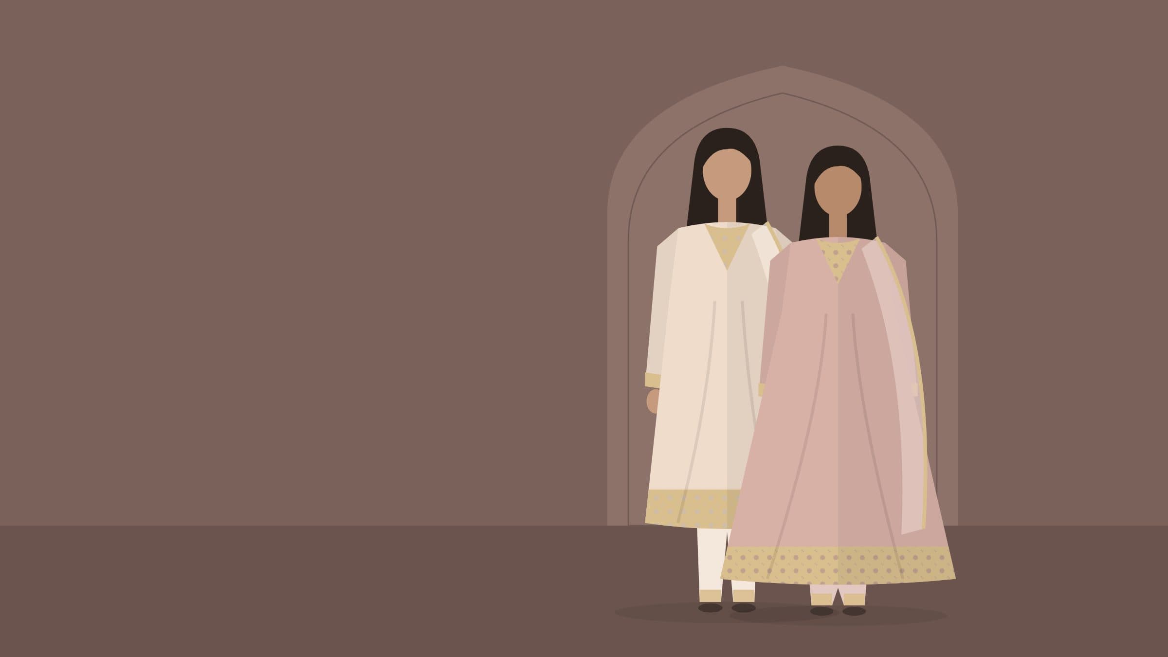 Two models in ivory and blush festive suits beneath a carved Mughal arch